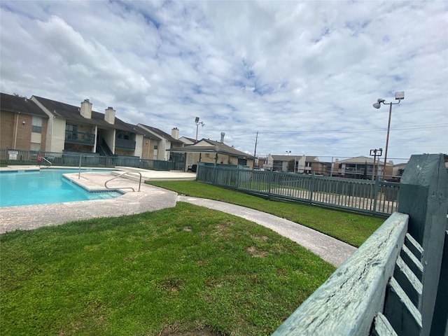 view of swimming pool with a yard and a patio