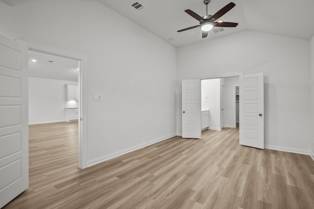 unfurnished bedroom with vaulted ceiling, light wood-type flooring, and ceiling fan