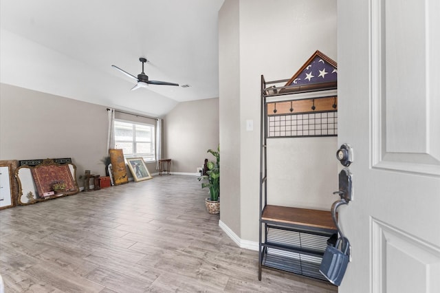 entrance foyer featuring ceiling fan, lofted ceiling, and light hardwood / wood-style flooring