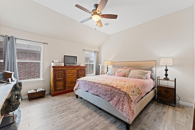 bedroom featuring ceiling fan, light hardwood / wood-style flooring, and vaulted ceiling