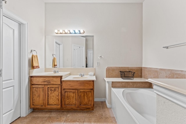 bathroom featuring tile patterned flooring, a bath, and vanity