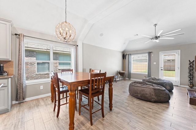 dining room with light hardwood / wood-style floors, a wealth of natural light, and lofted ceiling