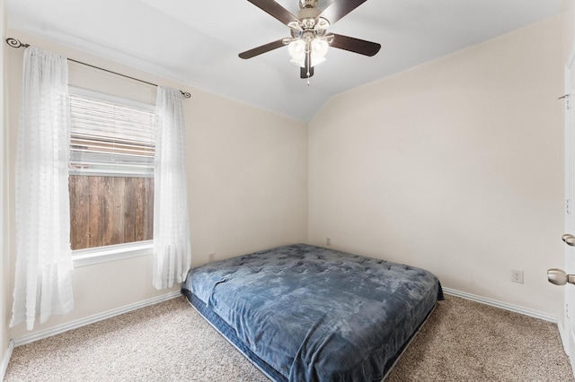 carpeted bedroom featuring ceiling fan and vaulted ceiling