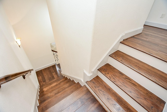 stairs featuring hardwood / wood-style flooring