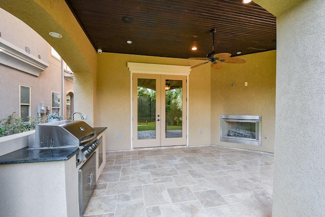 view of patio / terrace featuring ceiling fan, french doors, an outdoor fireplace, grilling area, and area for grilling