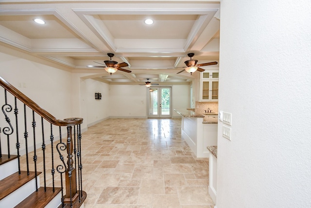 foyer featuring ceiling fan, french doors, coffered ceiling, beamed ceiling, and ornamental molding