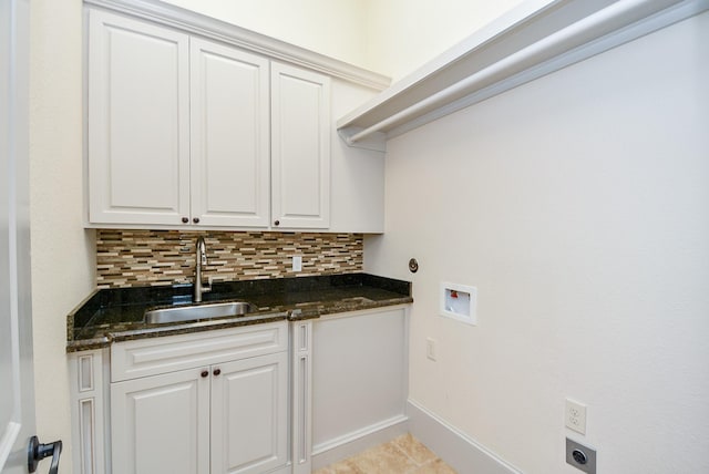 clothes washing area with sink, washer hookup, cabinets, hookup for an electric dryer, and light tile patterned floors