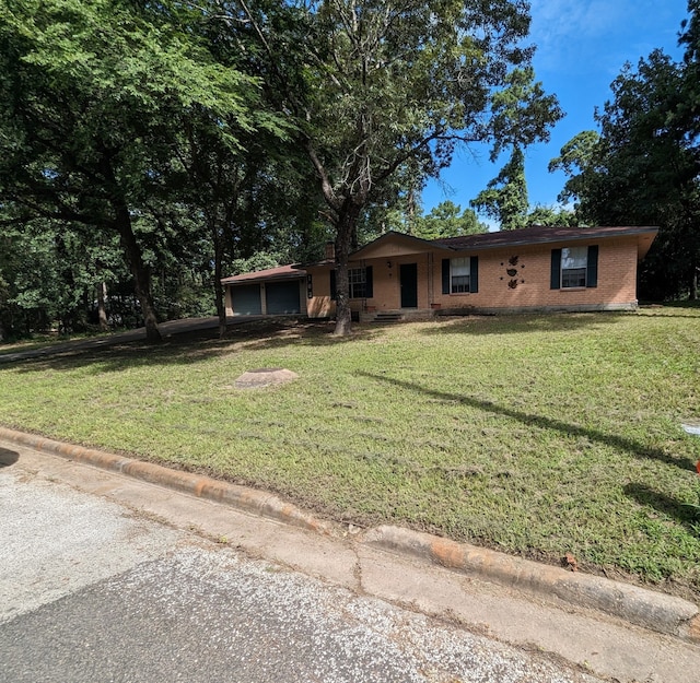 view of front of house with a front lawn and a garage