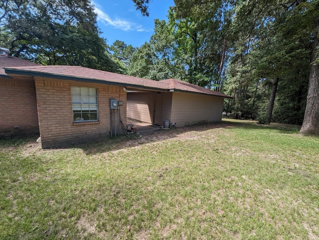 view of side of home with a lawn