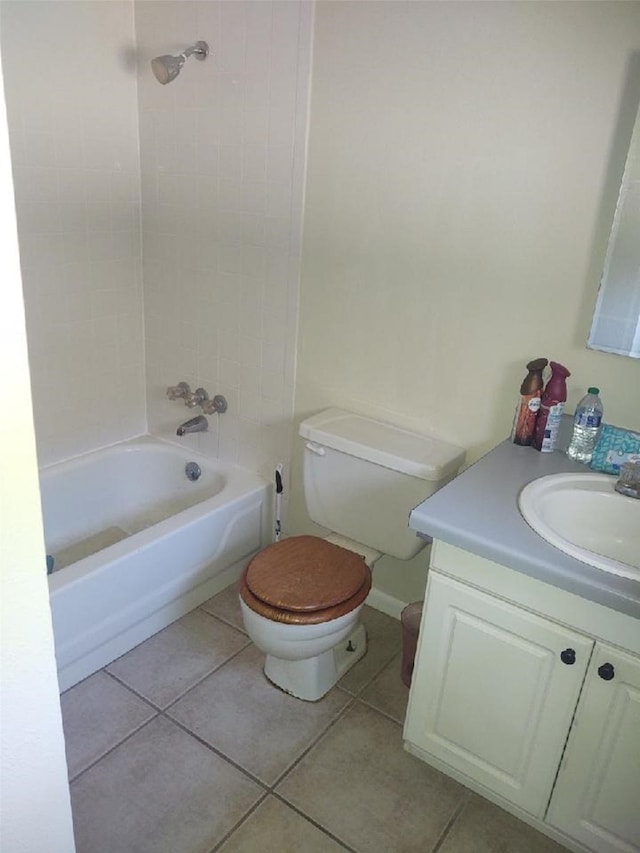 full bathroom featuring tiled shower / bath combo, tile flooring, toilet, and vanity