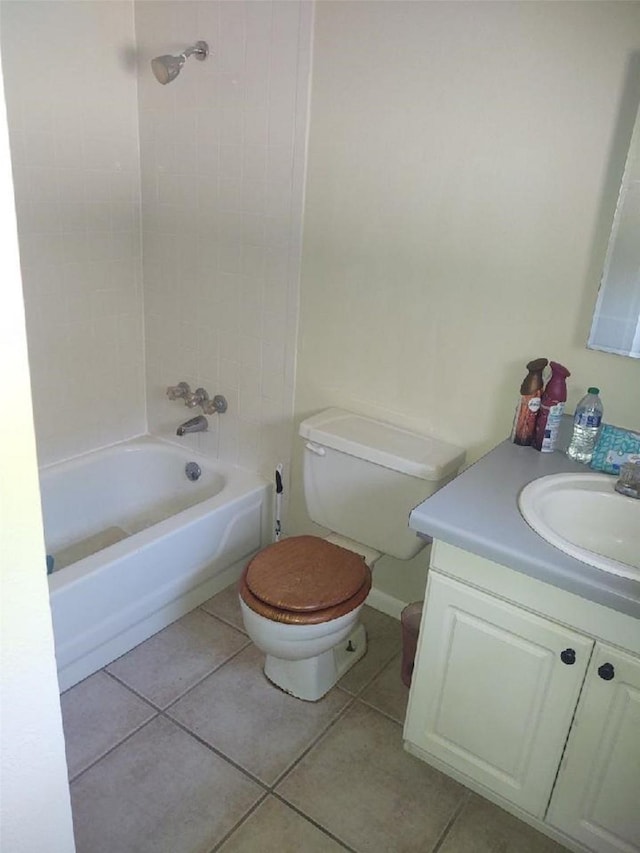 full bathroom featuring tile patterned floors, vanity, toilet, and tiled shower / bath