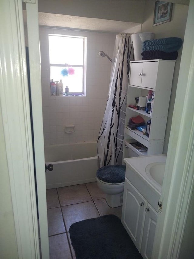 full bathroom with shower / tub combo, vanity, tile patterned floors, and toilet