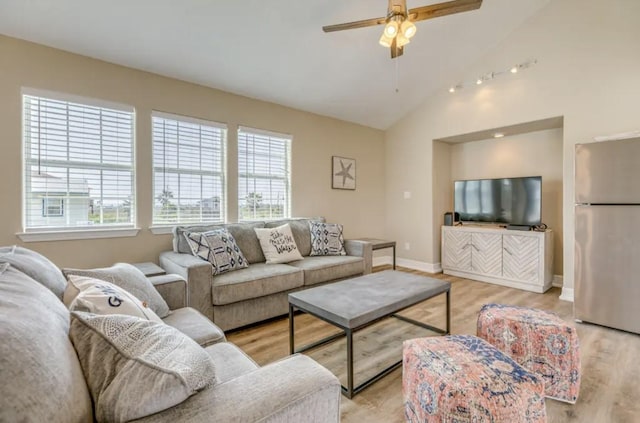 23171 Buena, Galveston, TX 77555 - living room featuring ceiling fan, a healthy amount of sunlight, lofted ceiling, and light wood-type flooring