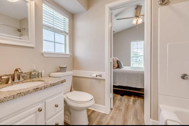 23171 Buena, Galveston, TX 77555 - bathroom featuring ceiling fan, hardwood / wood-style floors, lofted ceiling, toilet, and vanity