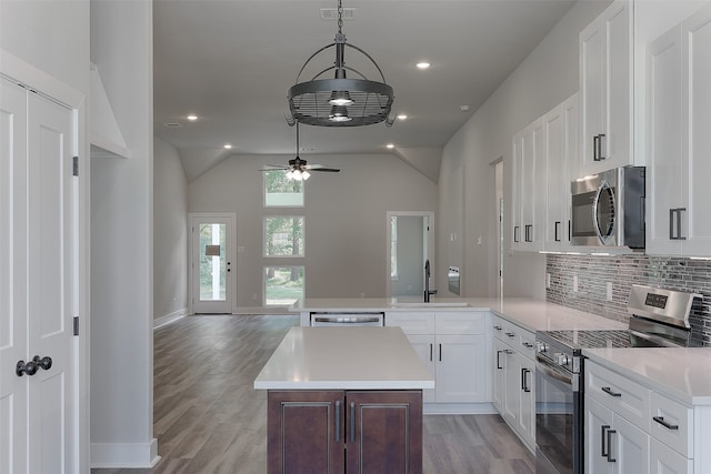 kitchen featuring pendant lighting, white cabinets, sink, ceiling fan, and appliances with stainless steel finishes