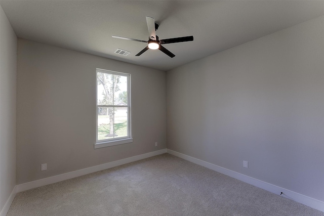 empty room featuring carpet flooring and ceiling fan