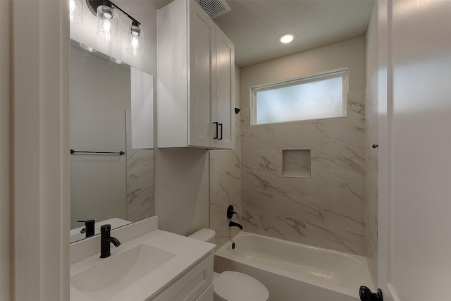 full bathroom featuring vanity, toilet, and tiled shower / bath