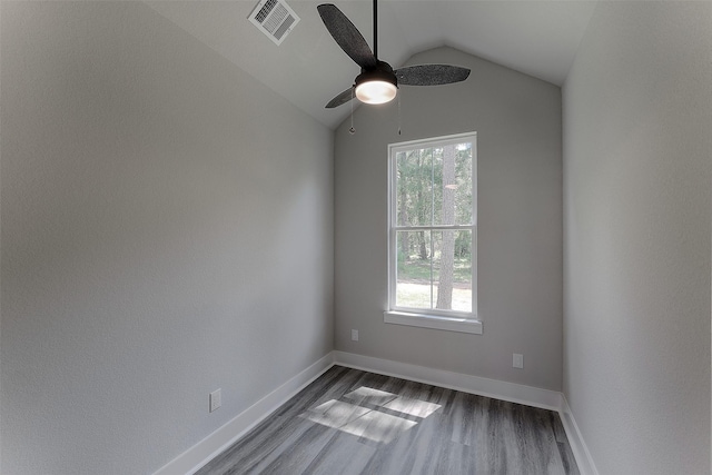 unfurnished room featuring ceiling fan, dark hardwood / wood-style flooring, and vaulted ceiling