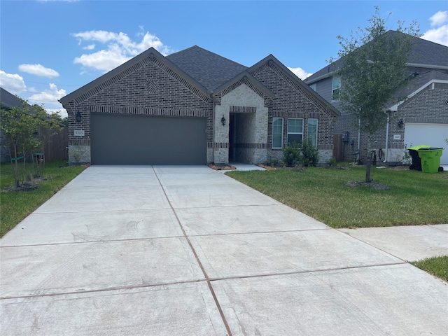 view of front of property featuring a front lawn and a garage