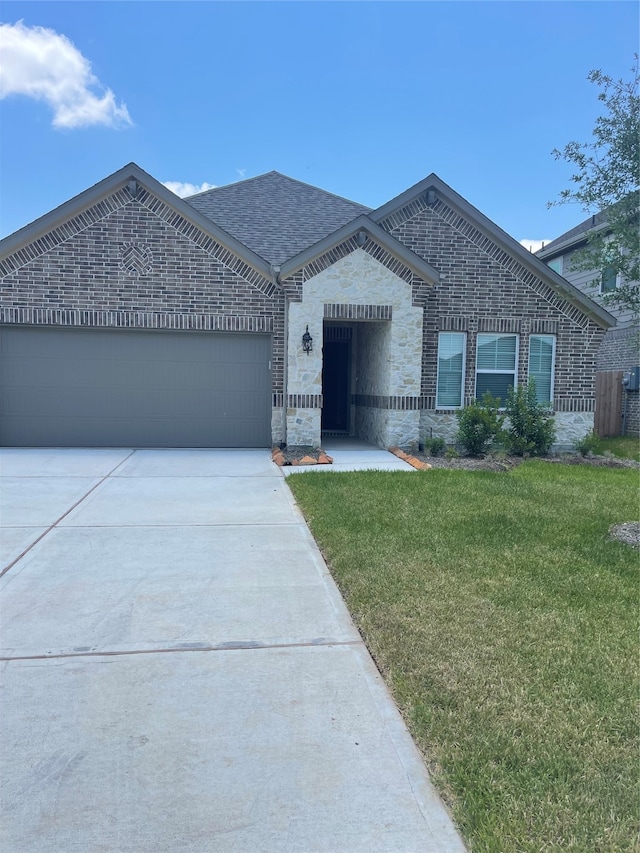 view of front facade with a garage and a front lawn