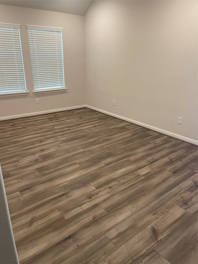 unfurnished room with dark hardwood / wood-style floors