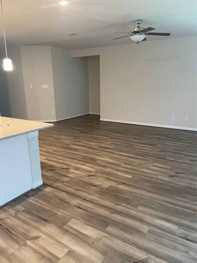 empty room featuring dark hardwood / wood-style flooring and ceiling fan