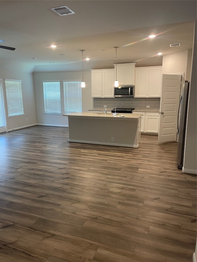 kitchen with white cabinets, dark wood-type flooring, and stainless steel appliances