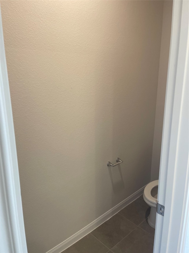 bathroom with tile flooring and toilet