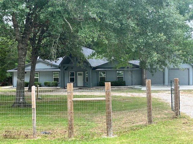 ranch-style home featuring a garage and a front yard