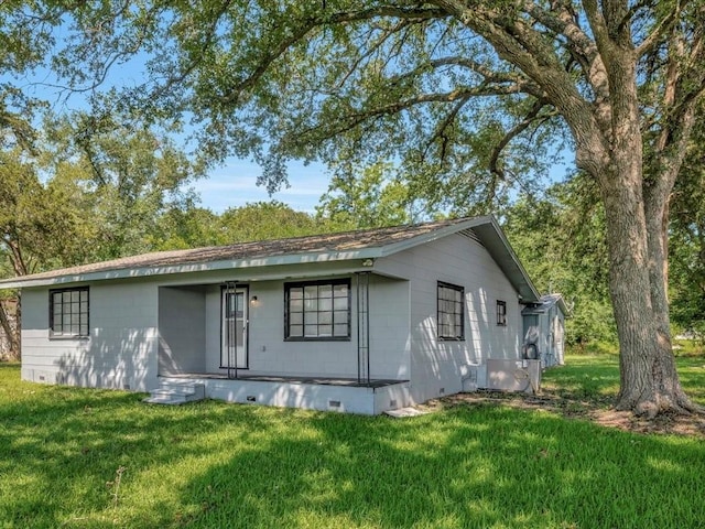 back of property featuring central AC unit and a yard