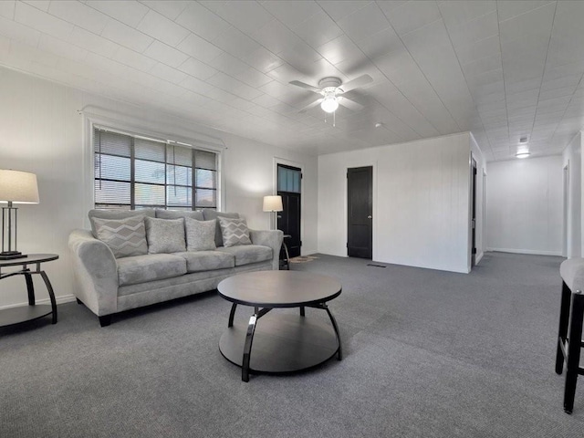 living room with ceiling fan and carpet