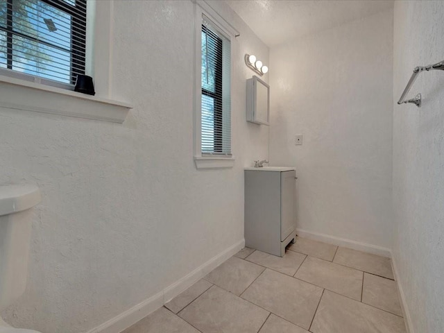 bathroom featuring vanity, tile patterned floors, and toilet