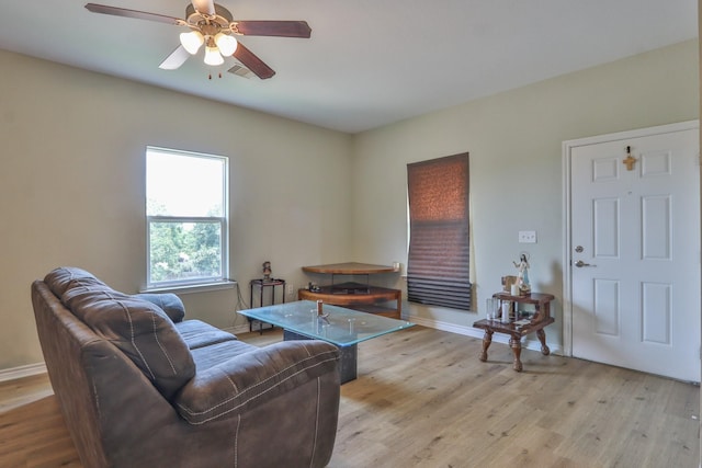 living room featuring ceiling fan and light hardwood / wood-style floors