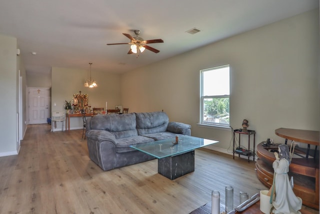 living room with ceiling fan and light hardwood / wood-style flooring