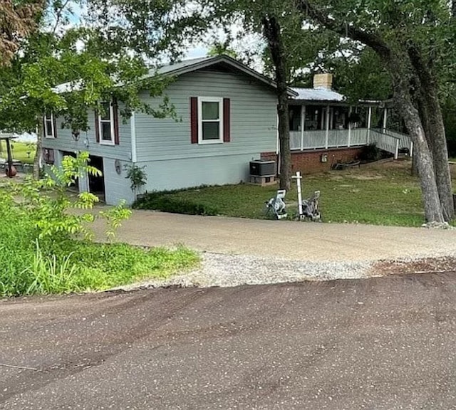 view of front of house with cooling unit and a porch