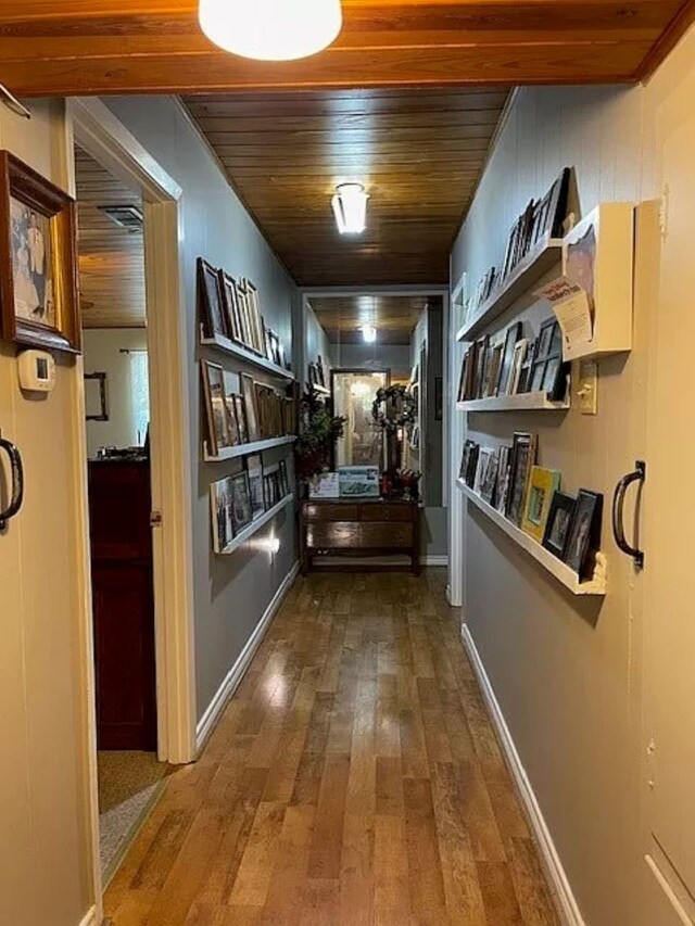 corridor featuring hardwood / wood-style flooring and wood ceiling