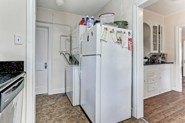 kitchen with white cabinetry, dishwasher, white refrigerator, stacked washer / drying machine, and a textured ceiling