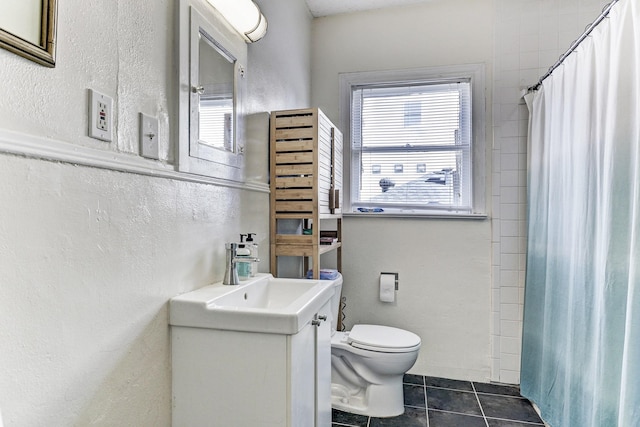 bathroom featuring tile patterned floors, vanity, curtained shower, and toilet