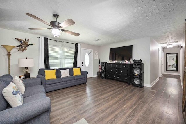 living room featuring a textured ceiling, dark hardwood / wood-style flooring, and ceiling fan