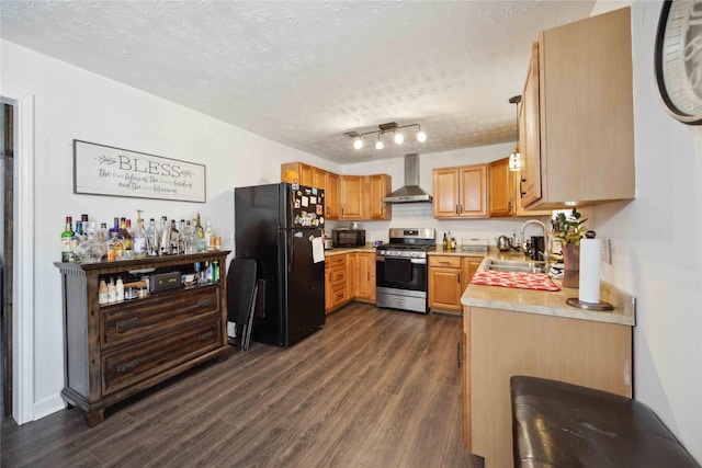 kitchen featuring black appliances, wall chimney exhaust hood, dark wood-type flooring, and a textured ceiling