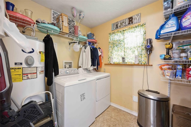 washroom with water heater, light tile patterned floors, and independent washer and dryer