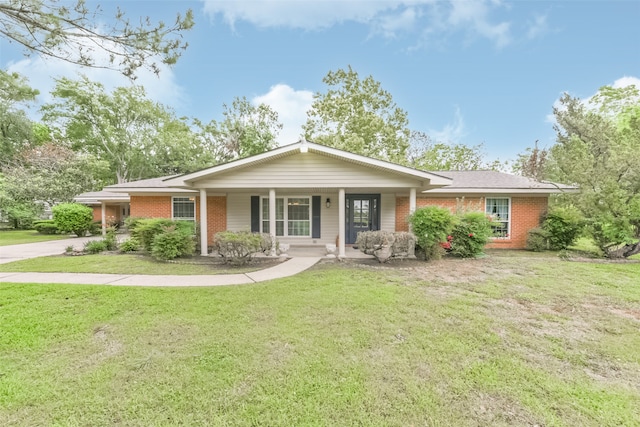 ranch-style home with covered porch and a front yard