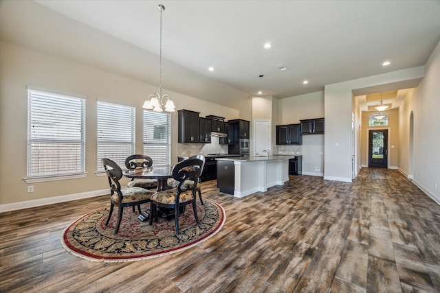 dining area with a notable chandelier and dark hardwood / wood-style floors