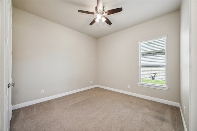 carpeted spare room with ceiling fan