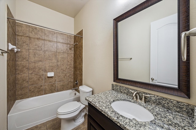 full bathroom featuring tile flooring, vanity, toilet, and tiled shower / bath combo