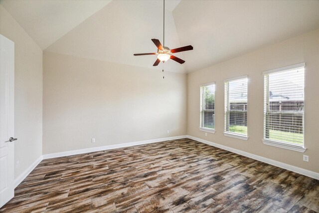 empty room featuring hardwood / wood-style flooring, ceiling fan, and vaulted ceiling