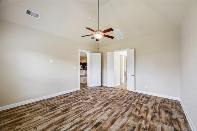 unfurnished bedroom featuring high vaulted ceiling, hardwood / wood-style floors, and ceiling fan