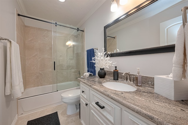 full bathroom with tile flooring, combined bath / shower with glass door, ornamental molding, toilet, and large vanity