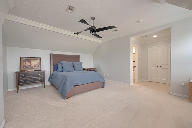 bedroom featuring a textured ceiling, ornamental molding, ceiling fan, and carpet floors