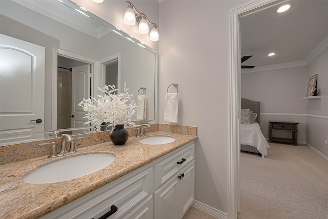 bathroom featuring dual sinks, ceiling fan, crown molding, and oversized vanity